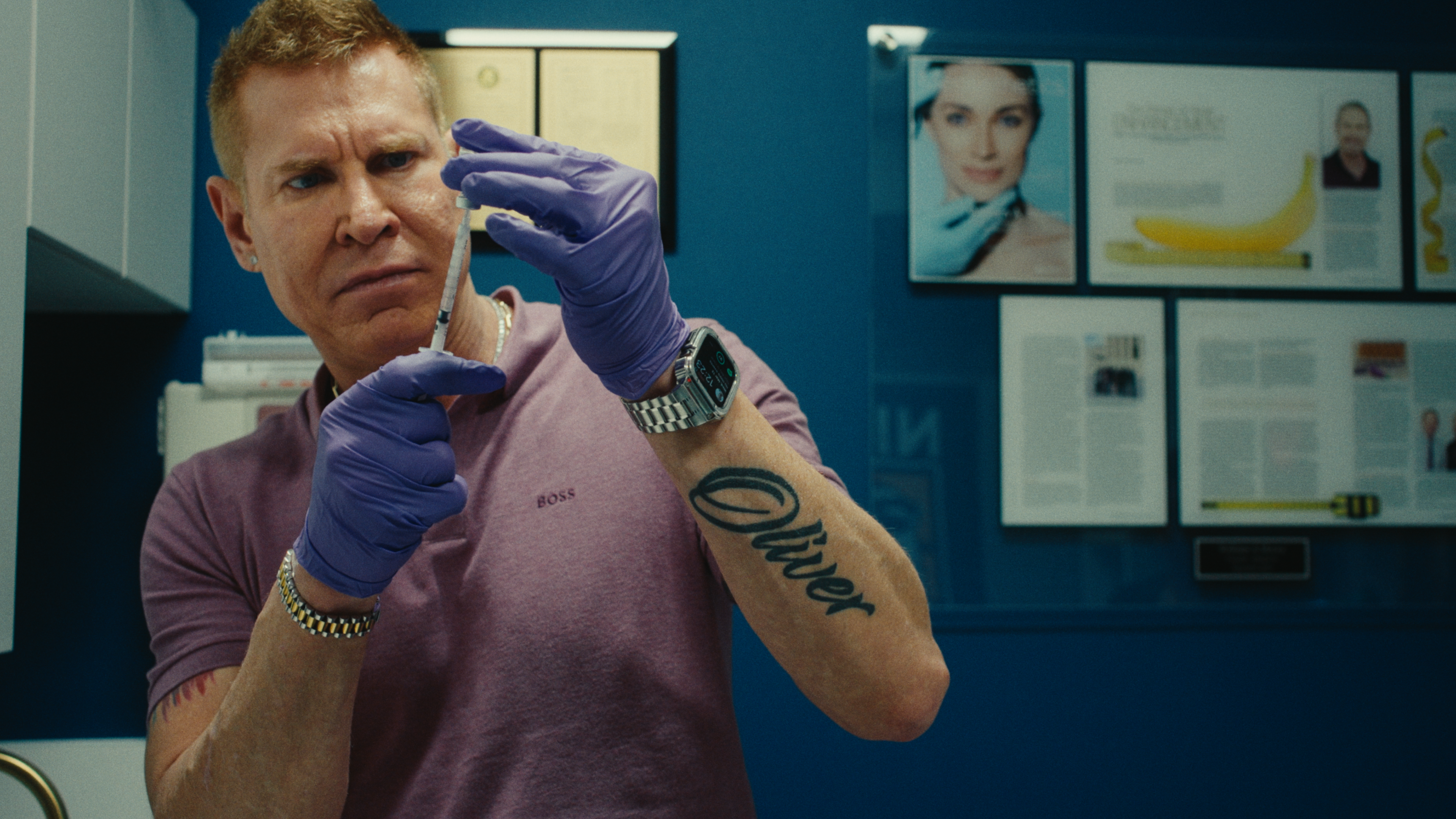 Still from "Manhood," a man prepares a syringe in a medical office.